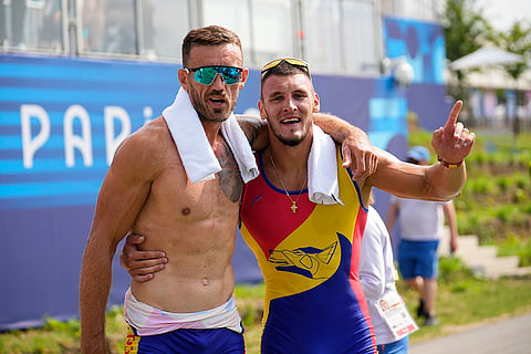 Andrei Sebastian Cornea and Marian Florian Enache pose for a photo after winning the gold